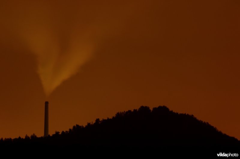 Enci-schouw en observant tegen het licht van nachtelijk Maastricht